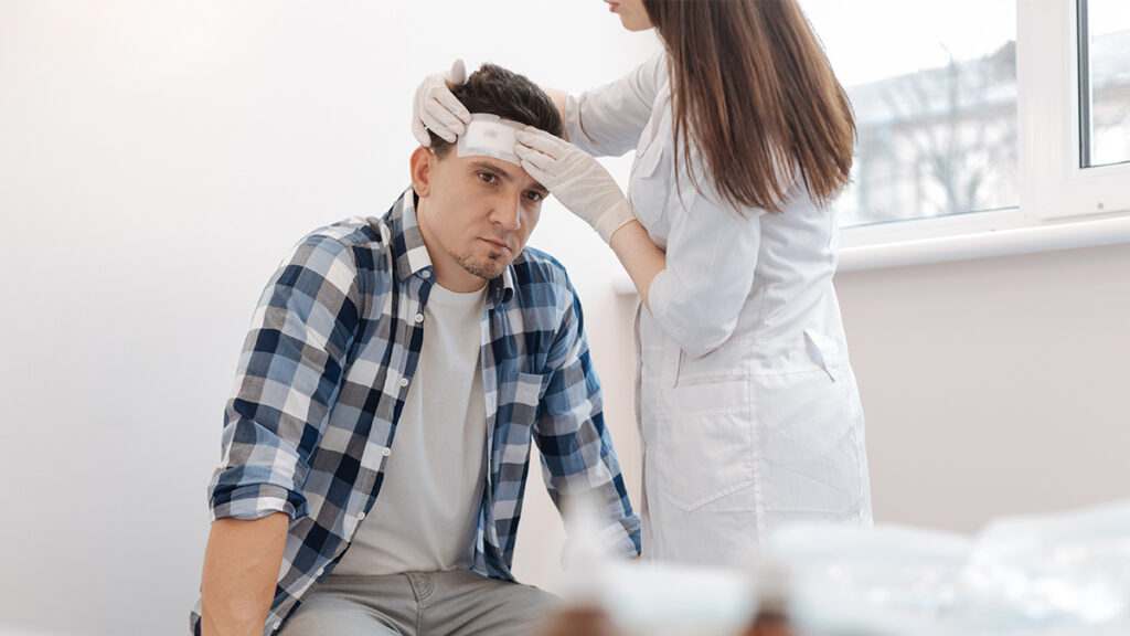 Traumatic-Brain-Injury-Team-Green-Law 2 | Team Green Law Doctor helps someone involved in a traumatic brain injury accident.