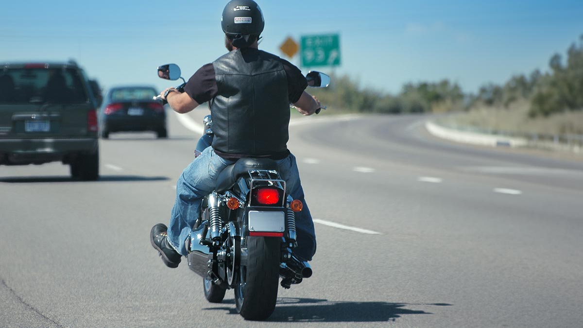 a motorcycle rider drives on the highway