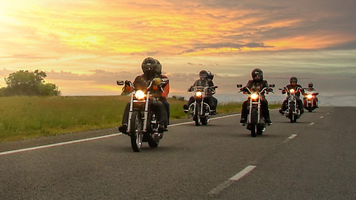 motorcycle drivers ride on open roadway